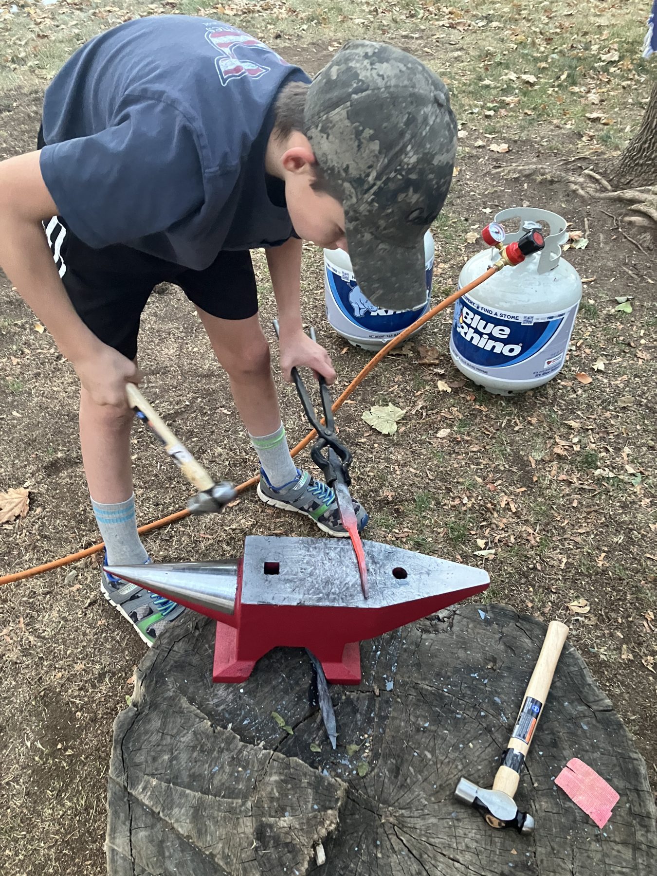 Forging at an anvil on a stump