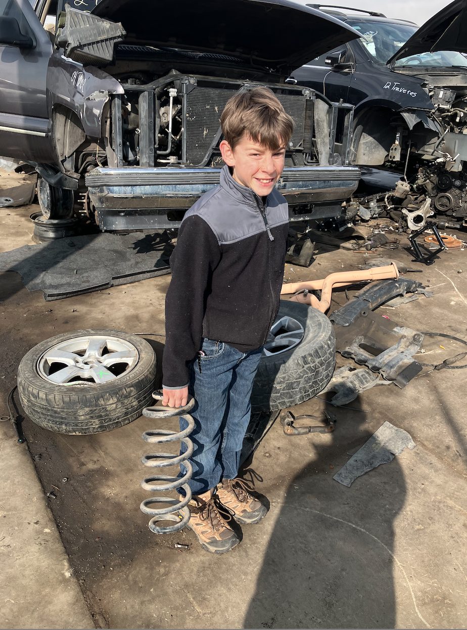 Holding a coil spring in a salvage yard